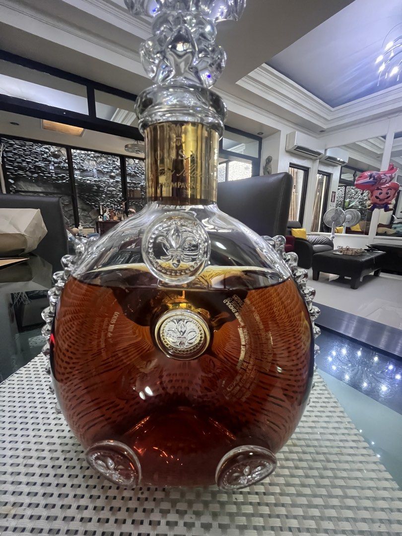 Louis XIII Grande Champagne Cognac (Category: Looking For) located in Pasig City. Submitted by jorgeboy9748 (Listing ID 1436348024, Image 1). Description: Beautiful bottle of Louis XIII Grande Champagne Cognac. The bottle has a unique shape with intricate glass detailing and a decorative stopper. The bottle has gold accents and the brand name is clearly visible. A luxurious addition to any collection..