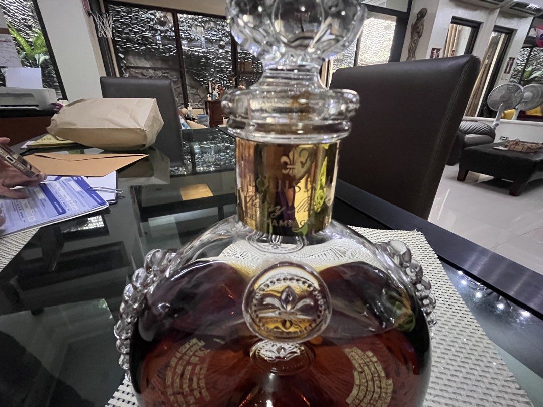 Louis XIII Grande Champagne Cognac (Category: Looking For) located in Pasig City. Submitted by jorgeboy9748 (Listing ID 1436348024, Image 3). Description: Beautiful bottle of Louis XIII Grande Champagne Cognac. The bottle has a unique shape with intricate glass detailing and a decorative stopper. The bottle has gold accents and the brand name is clearly visible. A luxurious addition to any collection..