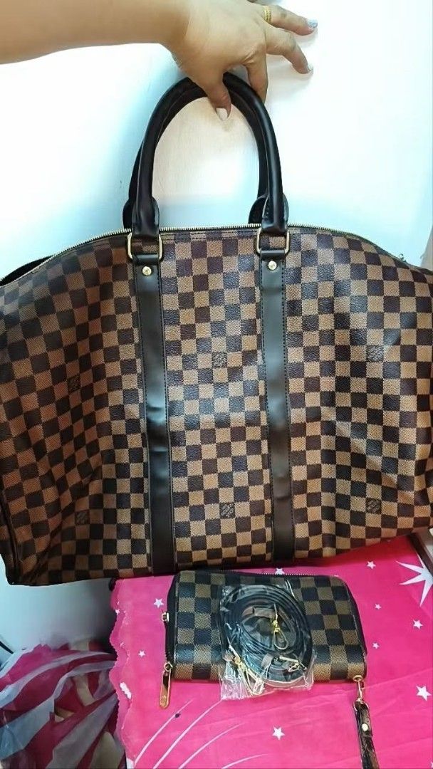LV Keepal 50 Duffel Bag (Category: Luxury Bags & Wallets) located in Cavite. Submitted by cheleshops (Listing ID 1436378546, Image 2). Description: For Sale!!! LV Keepal 50 Duffel Bag Negotiable Slightly Used Good for travel Japan source No code No dust bag - Keepal 50 check pattern handbag - Includes matching pouch with detachable strap - Red interior lining - Gold-tone hardware - Two top handles - Zipper closure - Spacious design, suitable for 