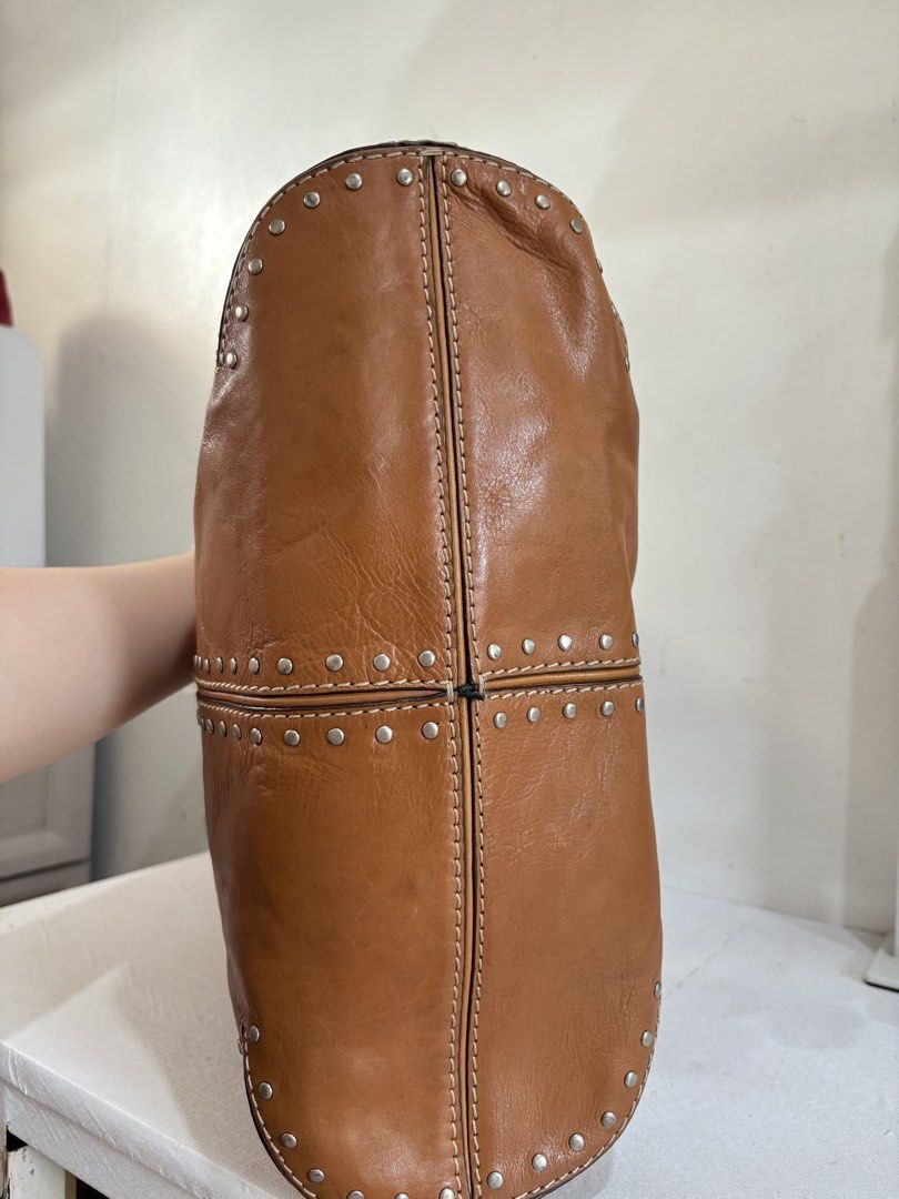 Michael Kors Studded Shoulder Bag/ Hobo Bag (Category: Shoulder Bags) located in Quezon City. Submitted by geminiselection (Listing ID 1436353057, Image 3). Description: Genuine Leather 💯 Authentic 💯 Super ganda padin in person Very spacious, perfecr pang everyday Nagkaroon lang ng watermark which is hindi naman halata overall maganda pa 🙂.