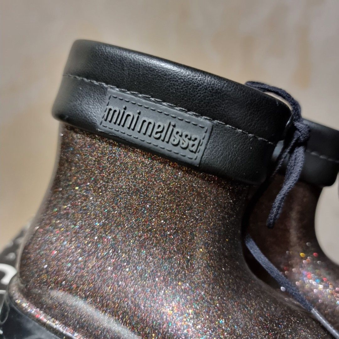 Mini Melissa Boots BB Black Glitter (Category: Babies & Kids Fashion) located in Manila. Submitted by fashiondera. (Listing ID 1436415794, Image 2). Description: - Mini Melissa rain boots - Color: Black glitter - Size: USA 5 - Includes original box - Lace-up design - Mini Melissa logo on the back.