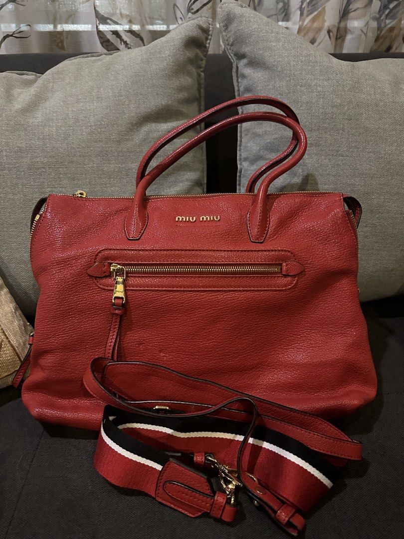 Miu Miu Red Leather Handbag (Category: Luxury Bags & Wallets) located in Manila. Submitted by jerramarieee (Listing ID 1436461997, Image 2). Description: - Authentic Miu Miu handbag - Color: Red - Material: Leather (textured) - Design: Top handle - Closure: Zip - Features: Front zip pocket, detachable shoulder strap - Hardware: Gold-tone - Branding: Miu Miu logo on front • Original Price: Approx. $1,495 (Approx. ₱86,000) • Selling Price: ₱15,000.