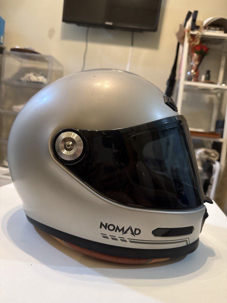 Nomad Camino Motorcycle Helmet (Category: Helmets and other Riding Gears) located in Cainta. Submitted by angelesasdfghjkl13 (Listing ID 1436422884, Image 3). Description: - Nomad Camino motorcycle helmet - Size: L (59-60) - Color: Silver exterior with black visor - DOT certified - Interior padding visible - Features "Adventure Awaits" print on the front “Kaka-ceramiclang” .