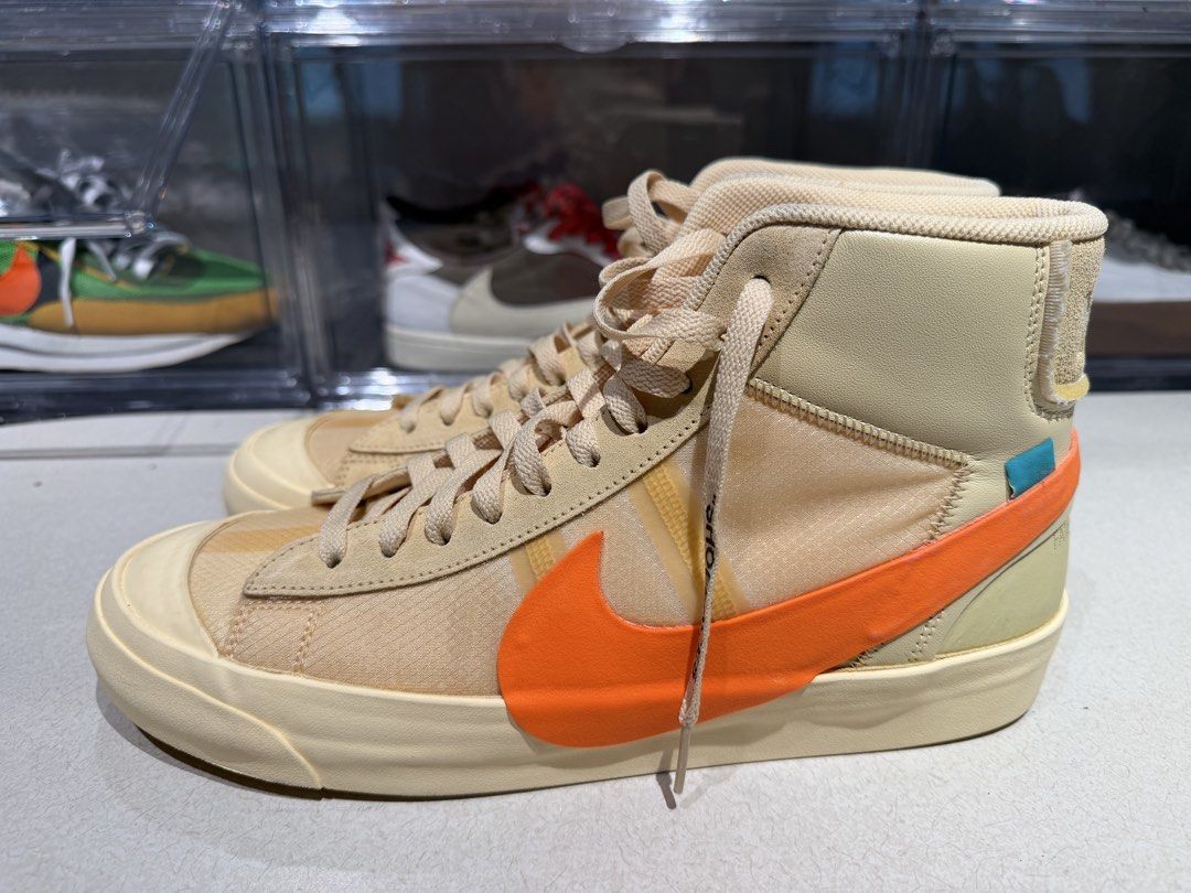 Off-White x Nike Blazer Mid (Category: Sneakers) located in Quezon City. Submitted by declutterqueenhigh5 (Listing ID 1436468419, Image 2). Description: - Off-White x Nike Blazer Mid sneakers - Cream and orange color scheme - Signature Off-White text detail - "SHOELACES" printed on laces - Orange Nike swoosh - High-top design - Cream sole -NEVER USED.