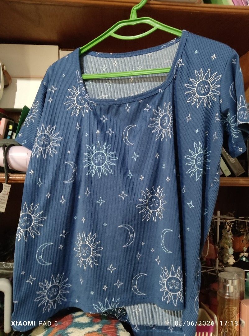 Pambahay shirts fits (L-XL) {50php each} (Category: Shirts) located in Pila. Submitted by heyz27 (Listing ID 1436378209, Image 2). Description: - Celestial print ribbed t-shirts - Unique sun, moon, and star design - Available colors: White and Blue - Features a scoop neck - Short sleeves - Perfect for casual wear.