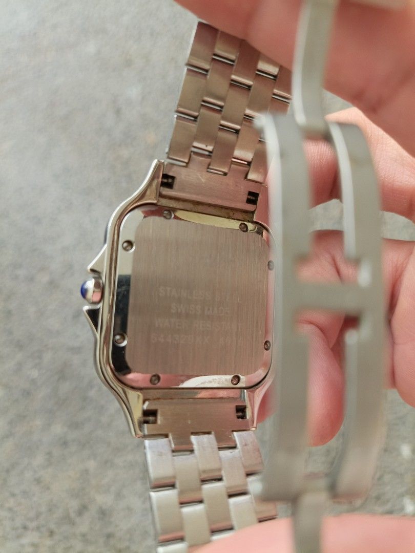 Panther Watch (Category: Luxury Watches) located in Cainta. Submitted by luxurypreloved2022 (Listing ID 1436357499, Image 2). Description: - Panther watch - Stainless steel case and bracelet - Square white dial - Black Roman numeral hour markers - Blue hands - Blue stone crown - Folding clasp - Water resistant Just extra links, no box.
