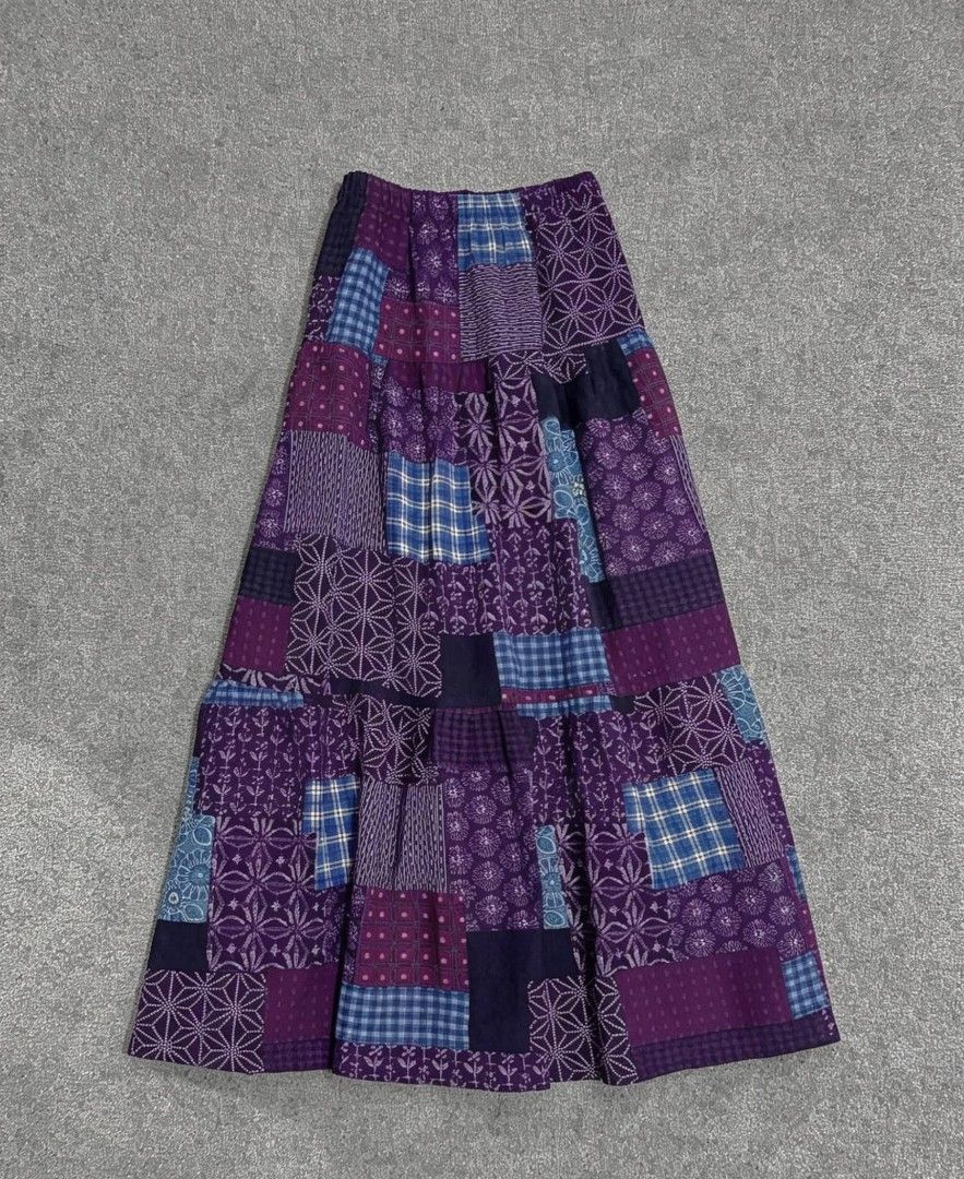 Patchwork Maxi Skirt (Category: Skirts) located in Mandaluyong City. Submitted by haerru (Listing ID 1436436668, Image 1). Description: Maxi skirt features a unique patchwork design in shades of purple and blue. It has a tiered construction, adding volume and movement. It has a comfortable elastic waistband. The skirt is a versatile piece that can be dressed up or down..