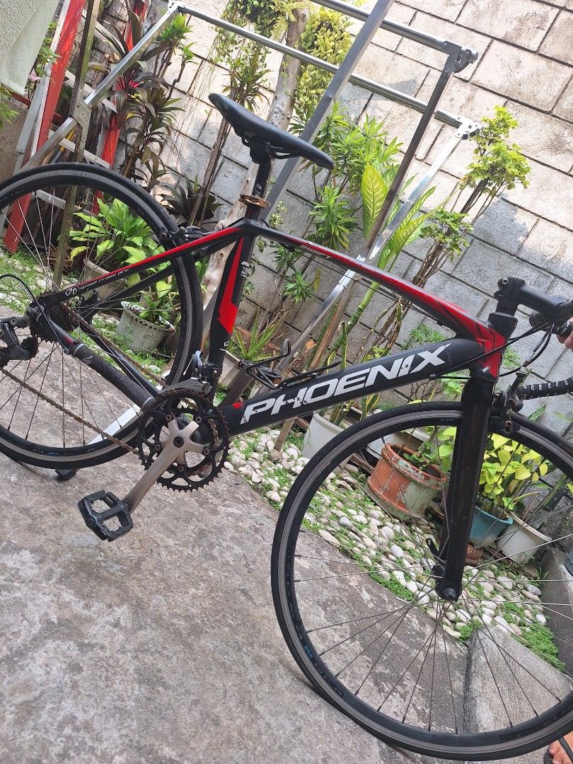 Phoenix Road Bike (Category: Bicycles) located in Caloocan City. Submitted by cee_empreloveditems (Listing ID 1436429532, Image 1). Description: Phoenix Speed Cross Pro Bike The PRICE STILL NEGOTIABLE, pwedeng pwede babaan, PM ME for more details. - Black and Red frame, Alluminum Alloy. - Has rusty on belt, flat tires and is heavily used, minor repair will work. - Free helmet. Reason for selling: wala na gumagamit kaya nakatambak nalang sa isang 