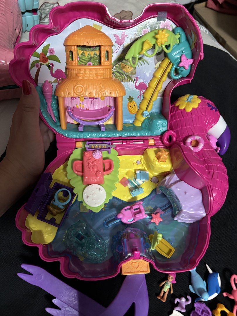 Polly Pocket Flamingo Playset (Category: Kids Toys) located in San Juan City. Submitted by ywkly (Listing ID 1436455659, Image 3). Description: - Flamingo-shaped Polly Pocket playset - Opens to reveal a tropical paradise - Includes a tower and a slide - Comes with mini figures, a surfboard, and sea creatures - Features a convenient handle for carrying - Vibrant pink color - Encourages imaginative play.