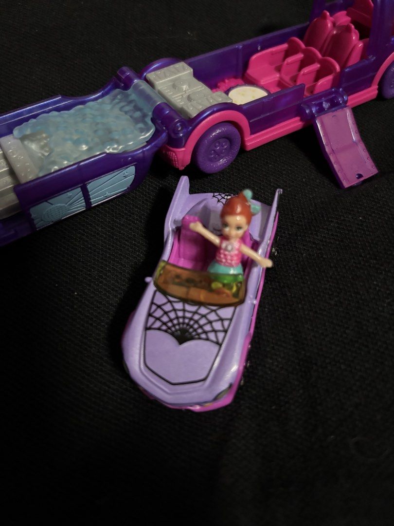 Polly Pocket Haunted House Playset (Category: Kids Toys) located in San Juan City. Submitted by ywkly (Listing ID 1436456489, Image 2). Description: - Polly Pocket Haunted House playset - Features a purple and pink haunted house - Includes a convertible car with spiderweb design - Comes with a Polly Pocket doll in a pink top and green skirt - Playset opens to reveal a bed, seats, and a table.