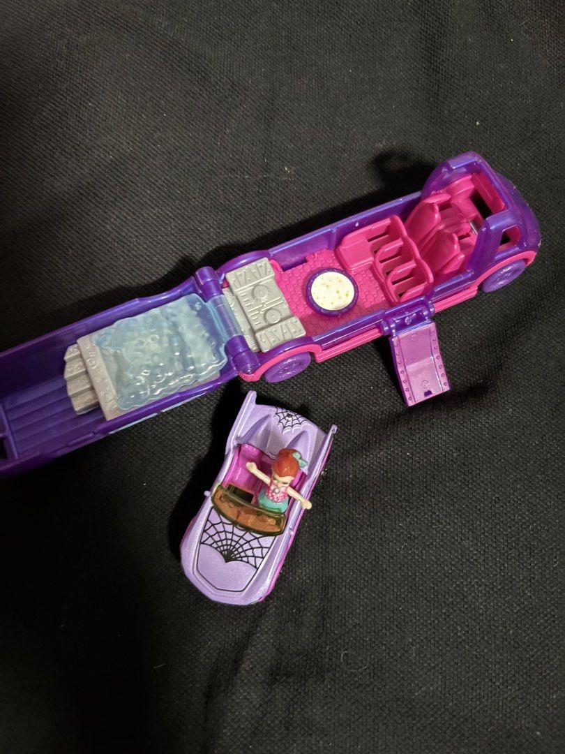 Polly Pocket Haunted House Playset (Category: Kids Toys) located in San Juan City. Submitted by ywkly (Listing ID 1436456489, Image 3). Description: - Polly Pocket Haunted House playset - Features a purple and pink haunted house - Includes a convertible car with spiderweb design - Comes with a Polly Pocket doll in a pink top and green skirt - Playset opens to reveal a bed, seats, and a table.