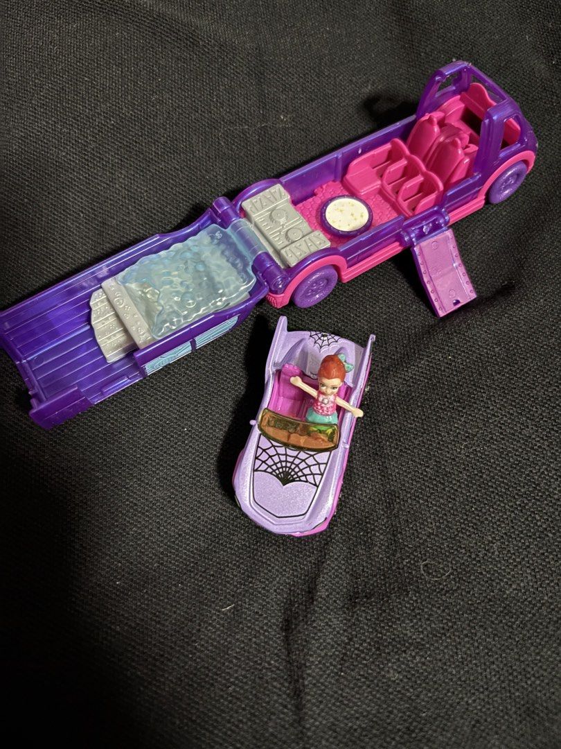 Polly Pocket Haunted House Playset (Category: Kids Toys) located in San Juan City. Submitted by ywkly (Listing ID 1436456489, Image 1). Description: - Polly Pocket Haunted House playset - Features a purple and pink haunted house - Includes a convertible car with spiderweb design - Comes with a Polly Pocket doll in a pink top and green skirt - Playset opens to reveal a bed, seats, and a table.
