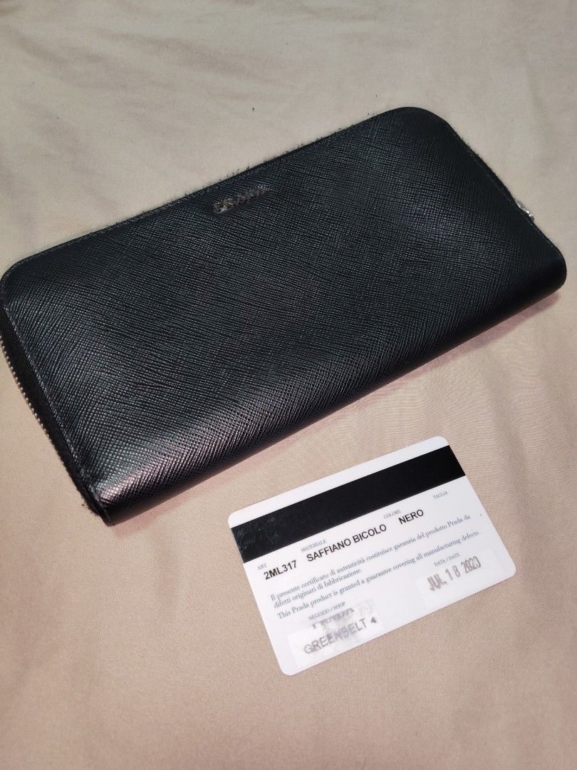 Prada Saffiano Bifold Wallet (Category: Luxury Bags & Wallets) located in Makati City. Submitted by theseasonstrend (Listing ID 1436294471, Image 1). Description: - Authentic Prada Saffiano Bifold Wallet - Black color - Zip-around closure - Multiple card slots - Clean interior - Smoothly functioning zipper - Includes authenticity card.