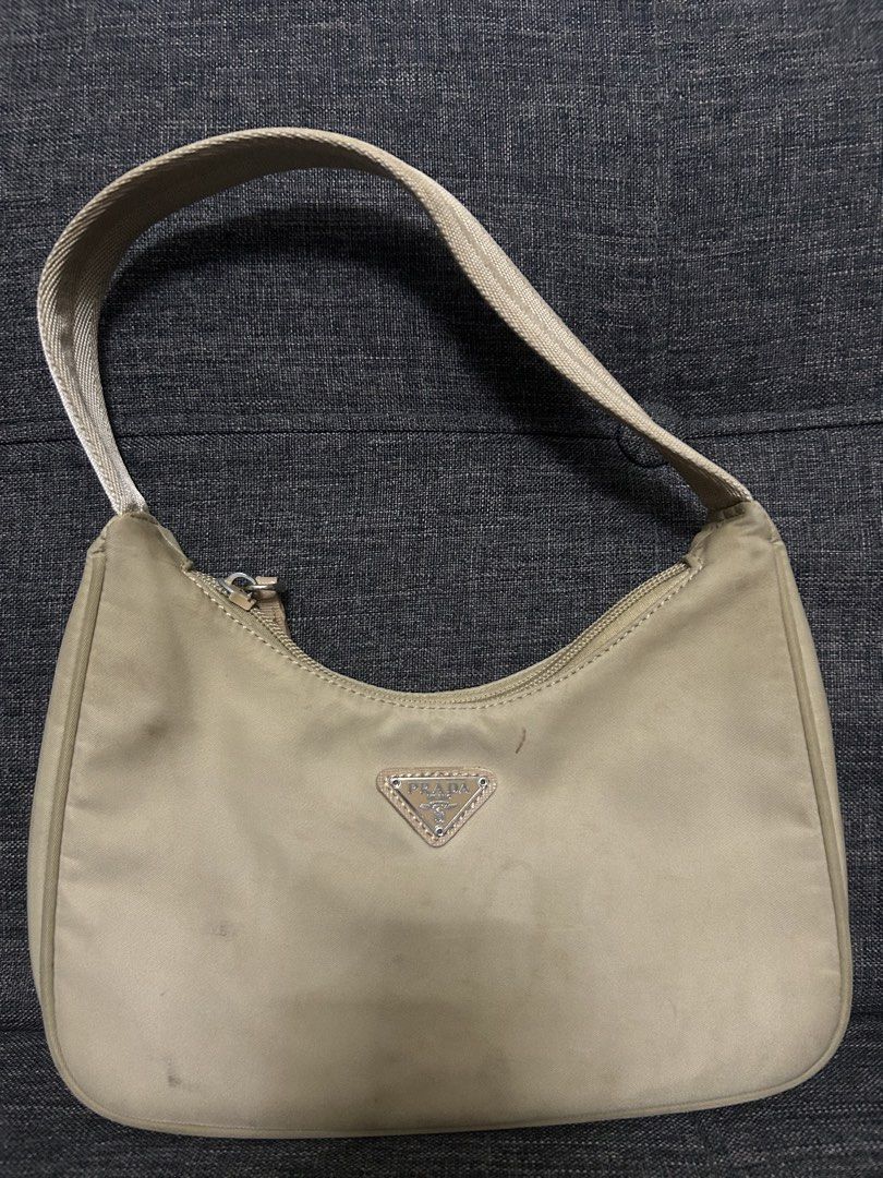 Prada Shoulder Bag (Category: Luxury Bags & Wallets) located in Dasmarinas. Submitted by trendyfitsph (Listing ID 1436409801, Image 1). Description: - Prada shoulder bag - Beige nylon exterior - Fabric strap - Prada logo on front and interior lining - Zipper closure.