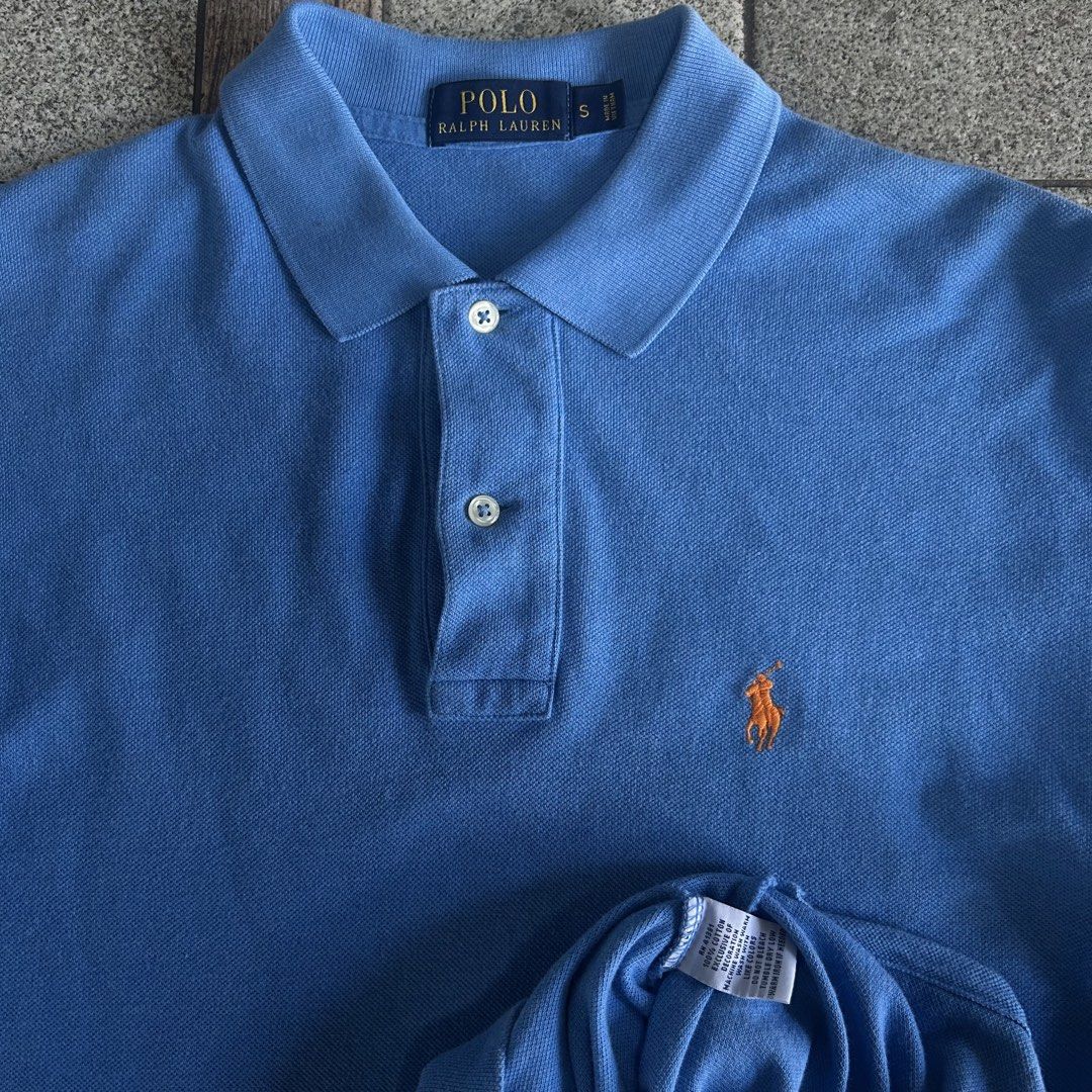 Ralph Lauren Polo Shirt - Blue (Category: Tshirts & Polo Shirts ) located in Quezon. Submitted by webtothecloset (Listing ID 1436356986, Image 2). Description: - Ralph Lauren polo shirt - Color: Blue - Size: S - Features the iconic orange polo player logo - Collared neckline with a three-button placket - Made from comfortable fabric - Perfect for casual wear.