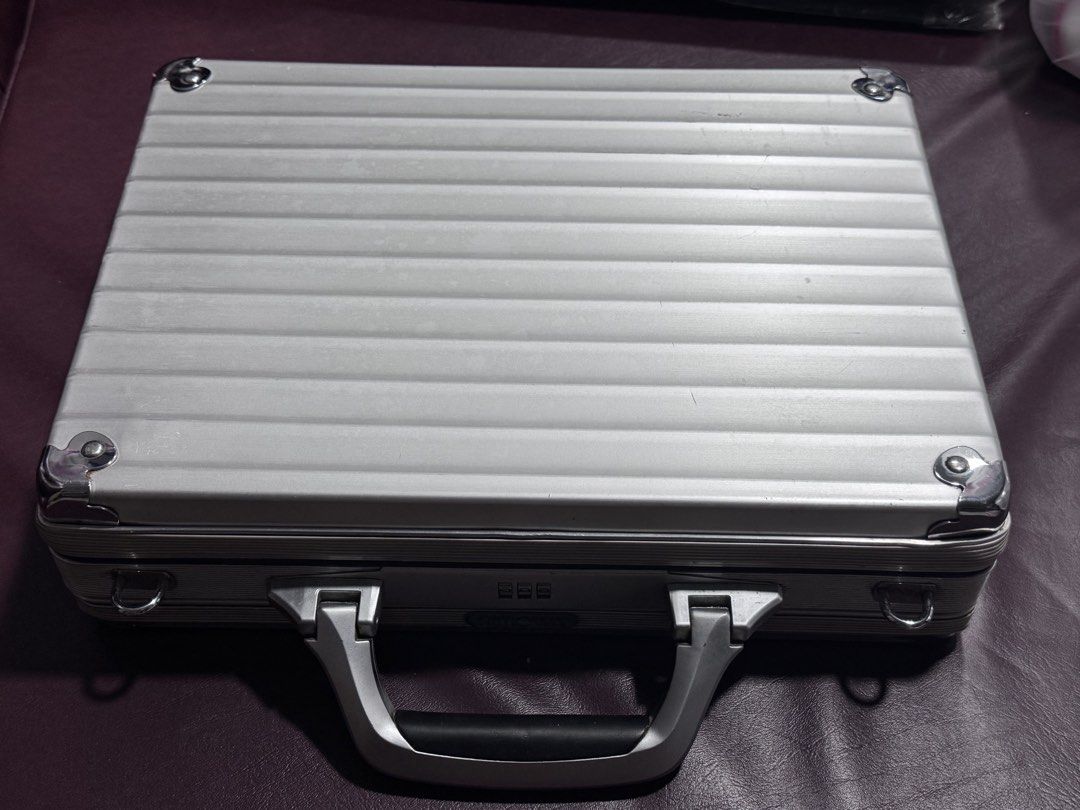 Rimowa Aluminum Briefcase (Category: Briefcases) located in Paranaque City. Submitted by destineshoppe (Listing ID 1436453220, Image 1). Description: - Authentic Rimowa aluminum briefcase - Silver exterior - Combination lock - Interior with multiple pockets and strap .