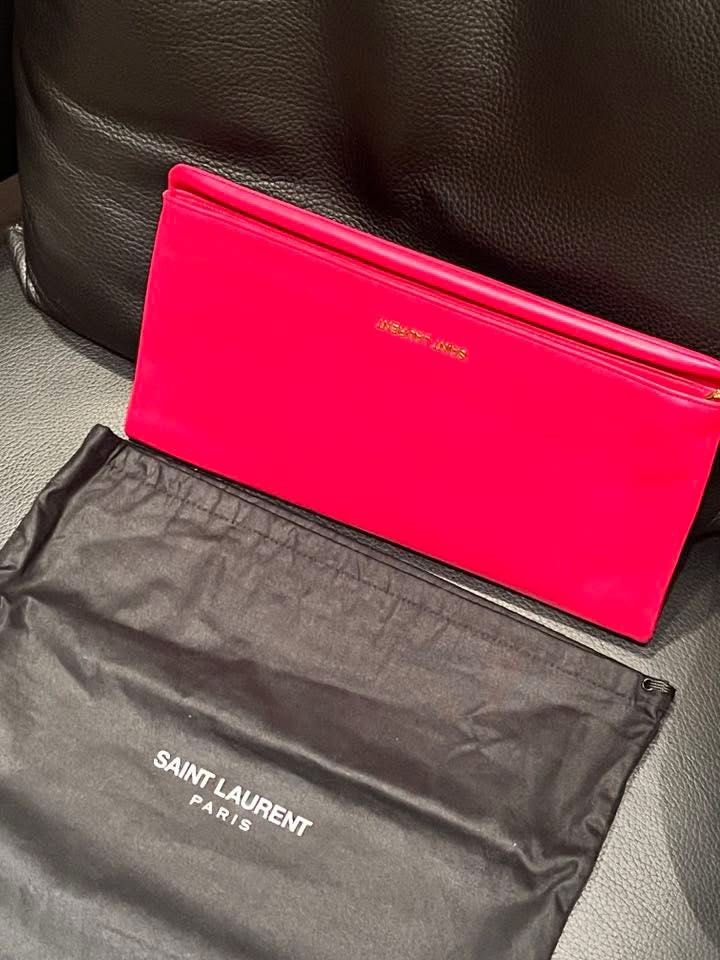 Saint Laurent Clutch in Hot Pink (Category: Luxury Bags & Wallets) located in Makati City. Submitted by aiahscloset (Listing ID 1436412817, Image 3). Description: - Authentic Saint Laurent clutch - Bright pink leather - Gold-colored Saint Laurent logo - Includes dust bag - Rectangular shape, fold-over style - Interior matches exterior color.