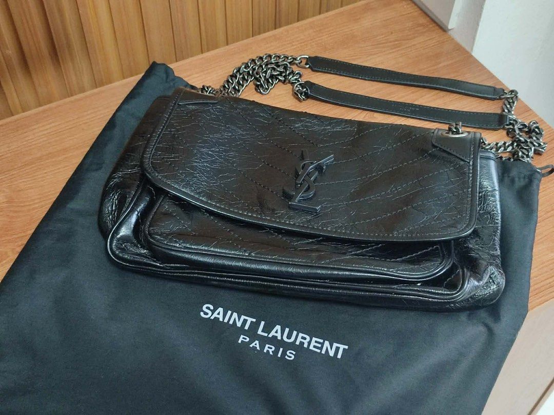 Saint Laurent Medium Niki Bag (Category: Luxury Bags & Wallets) located in Manila. Submitted by shersantos (Listing ID 1436448614, Image 2). Description: - Saint Laurent black leather shoulder bag - Chain strap - Flap closure with YSL logo - Includes dust bag - Interior: zippered pocket and snap closure pocket - Quilted design - Saint Laurent Paris logo visible 🖤 FOR SALE: Saint Laurent Medium Niki Bag 🖤 Timeless, edgy, and effortlessly cool — 