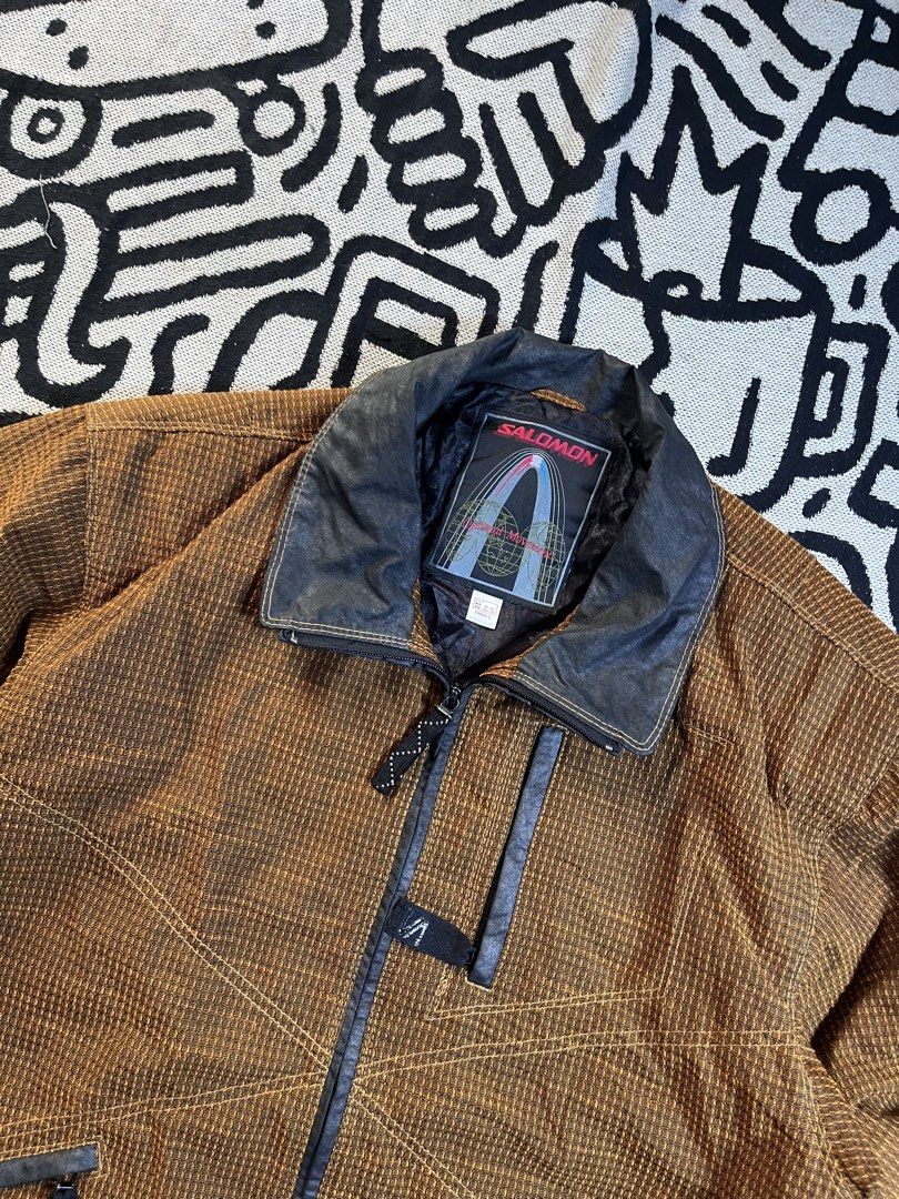 Salomon Warmtech Dima (Category: Coats, Jackets and Outerwear) located in Silang. Submitted by yusthrift (Listing ID 1436335341, Image 3). Description: - Vintage Salomon winter jacket - Brown and black color scheme - Unique checkered pattern - Zip-up front - Multiple pockets - Stylish collar - Salomon logo on collar and sleeve - Warm and durable - Perfect for cold weather Size: L on tag unisex 25 inc width 28 inc length Issue : Last pic Excellent