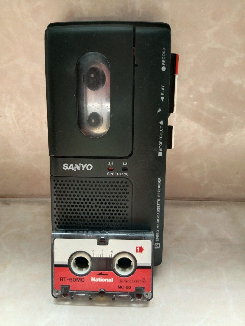 Sanyo Microcassette Recorder (Category: Portable Audio Accessories) located in Bulacan. Submitted by dyazpuzhpley021577r (Listing ID 1436319535, Image 1). Description: - Sanyo microcassette recorder - Functions: Record, Play, Stop/Eject - Includes: National RT-60MC microcassette tape - Speed Options: 2.4 and 1.2 not working with power hizzing sounds .