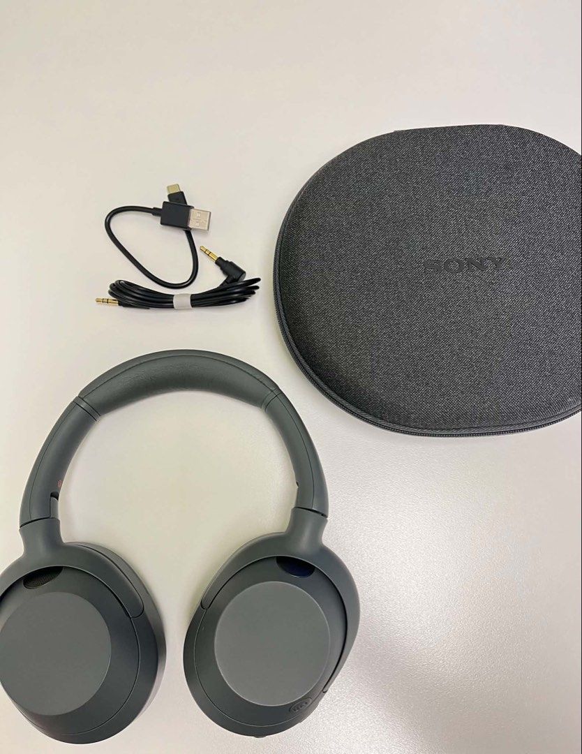 Sony ULT Wear Headphones (Category: Headphones & Headsets) located in Caloocan City. Submitted by angelsshps (Listing ID 1436382843, Image 2). Description: - Sony ULT Wear headphones - Gray color - Includes carrying case, charging cable, and audio cable - Features ULT Power Sound technology - Sony logo on headband.