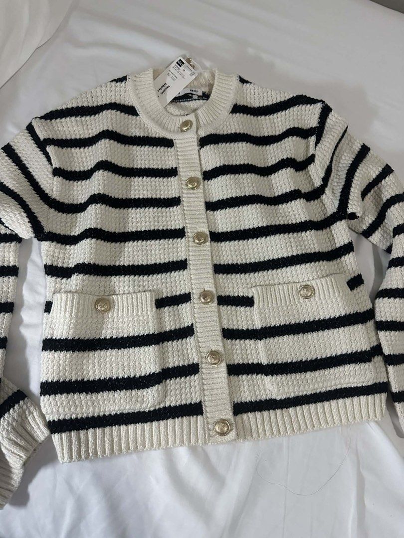 Striped Cardigan with Gold Buttons (Category: Coats, Jackets and Outerwear) located in Manila. Submitted by majimi (Listing ID 1436383962, Image 1). Description: Cream and black striped cardigan with gold buttons. Features two front pockets with gold button details. The cardigan has a round neckline and long sleeves. Includes a tag..
