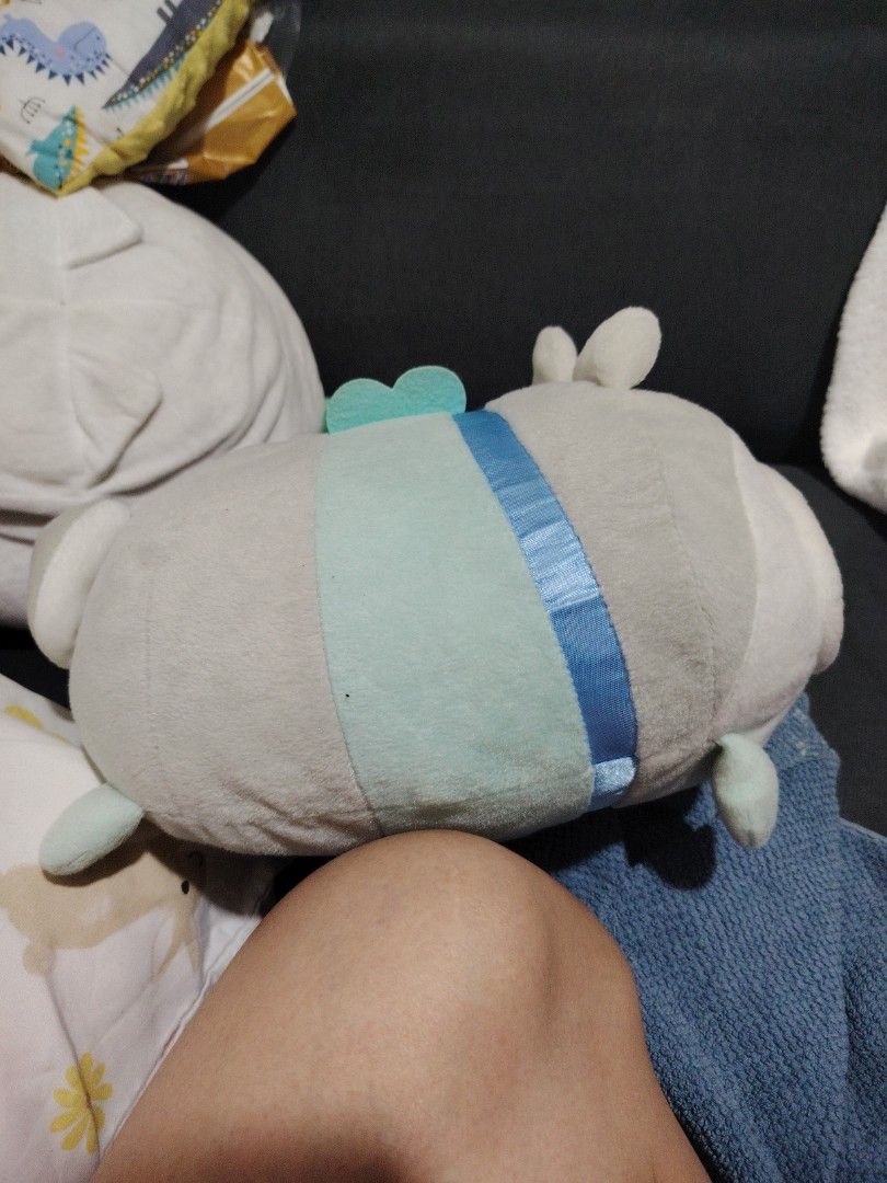 Sumikko Gurashi Frog Plush (Category: Plushies & Soft Toys) located in Makati City. Submitted by jayclutter0976004 (Listing ID 1436370876, Image 2). Description: Adorable Sumikko Gurashi plush features a frog character wearing a cute hood. It has a light green body, brown eyes, and a stitched mouth. The hood is gray with yellow inner ears. It's a soft and cuddly toy, perfect for any Sumikko Gurashi fan or plushie collector..