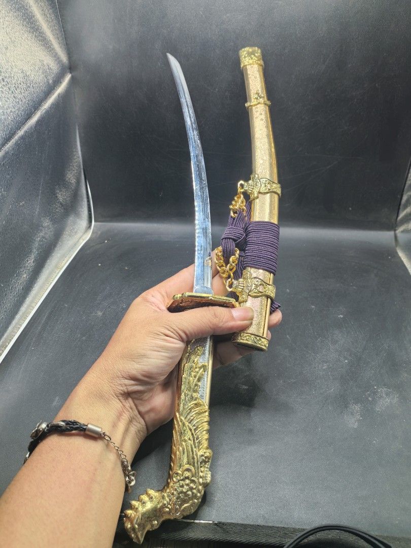 Sword Toy Display Model (Category: Toys & Games) located in Cebu City. Submitted by dudes_villanueva (Listing ID 1436293813, Image 2). Description: Kat-ana Sord Display Model Material: Metal Plated Like New 📌In excellent condition. 📌Phoenix Handle. 📌No Edge. Length: 18 inches.