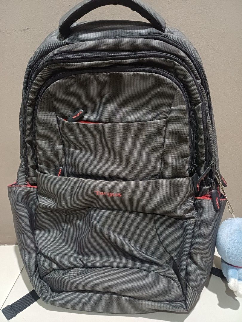 Targus Backpack (Category: Backpacks) located in Manila. Submitted by milesaway24 (Listing ID 1436433712, Image 2). Description: - Durable Targus backpack - Multiple compartments for organized storage - Padded laptop compartment - Several accessory pockets - Comfortable handle and adjustable shoulder straps - Sleek design with striped pattern and red accents - Interior with zippered pockets and ample space.