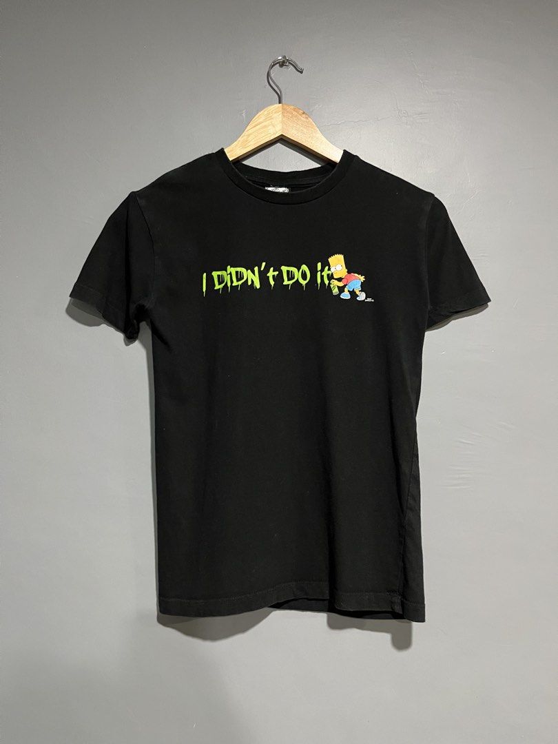 The Simpsons Bart T-shirt Size 10 (Category: Tshirts & Polo Shirts ) located in Maasin. Submitted by niconii090 (Listing ID 1436295784, Image 1). Description: - Black T-shirt featuring Bart Simpson. - Iconic "I Didn't Do It" phrase. - Regular fit. - Simpsons logo visible on tag. ✅ 9/10 condition 📏16x23 (inches).