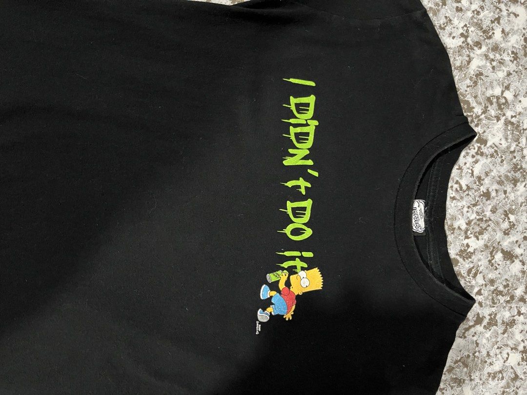 The Simpsons Bart T-shirt Size 10 (Category: Tshirts & Polo Shirts ) located in Maasin. Submitted by niconii090 (Listing ID 1436295784, Image 2). Description: - Black T-shirt featuring Bart Simpson. - Iconic "I Didn't Do It" phrase. - Regular fit. - Simpsons logo visible on tag. ✅ 9/10 condition 📏16x23 (inches).