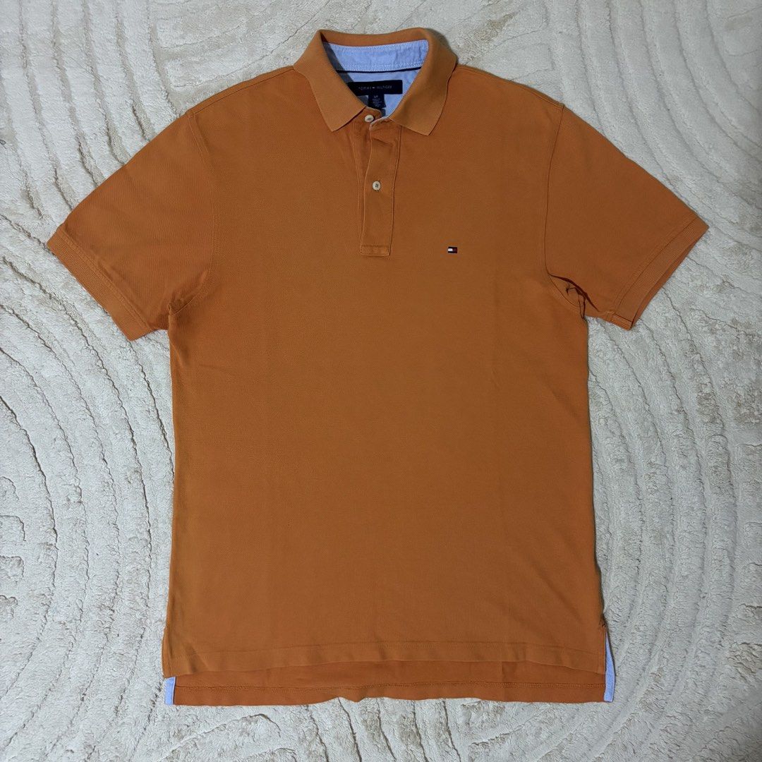 Tommy Hilfiger Orange Polo Shirt (Category: Tshirts & Polo Shirts ) located in Quezon City. Submitted by grailph (Listing ID 1436408468, Image 1). Description: - Orange Tommy Hilfiger polo shirt - Classic polo collar with blue lining - Small on tag - Dimensions 20”x29”-31” - Small embroidered logo on chest - Three-button placket - Short sleeves - Straight hem - Made of cotton Color rate 8/10 Issue last 2 pics.