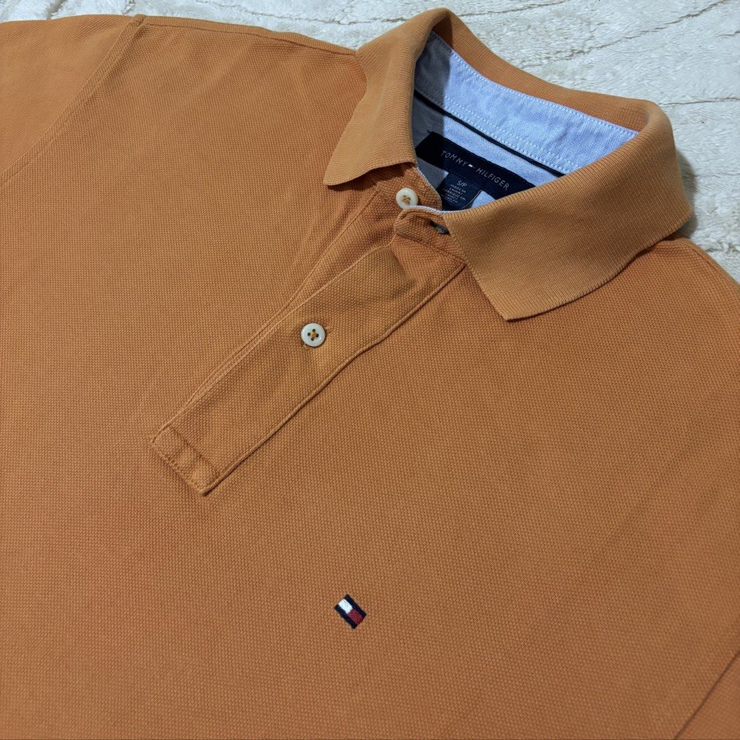 Tommy Hilfiger Orange Polo Shirt (Category: Tshirts & Polo Shirts ) located in Quezon City. Submitted by grailph (Listing ID 1436408468, Image 2). Description: - Orange Tommy Hilfiger polo shirt - Classic polo collar with blue lining - Small on tag - Dimensions 20”x29”-31” - Small embroidered logo on chest - Three-button placket - Short sleeves - Straight hem - Made of cotton Color rate 8/10 Issue last 2 pics.