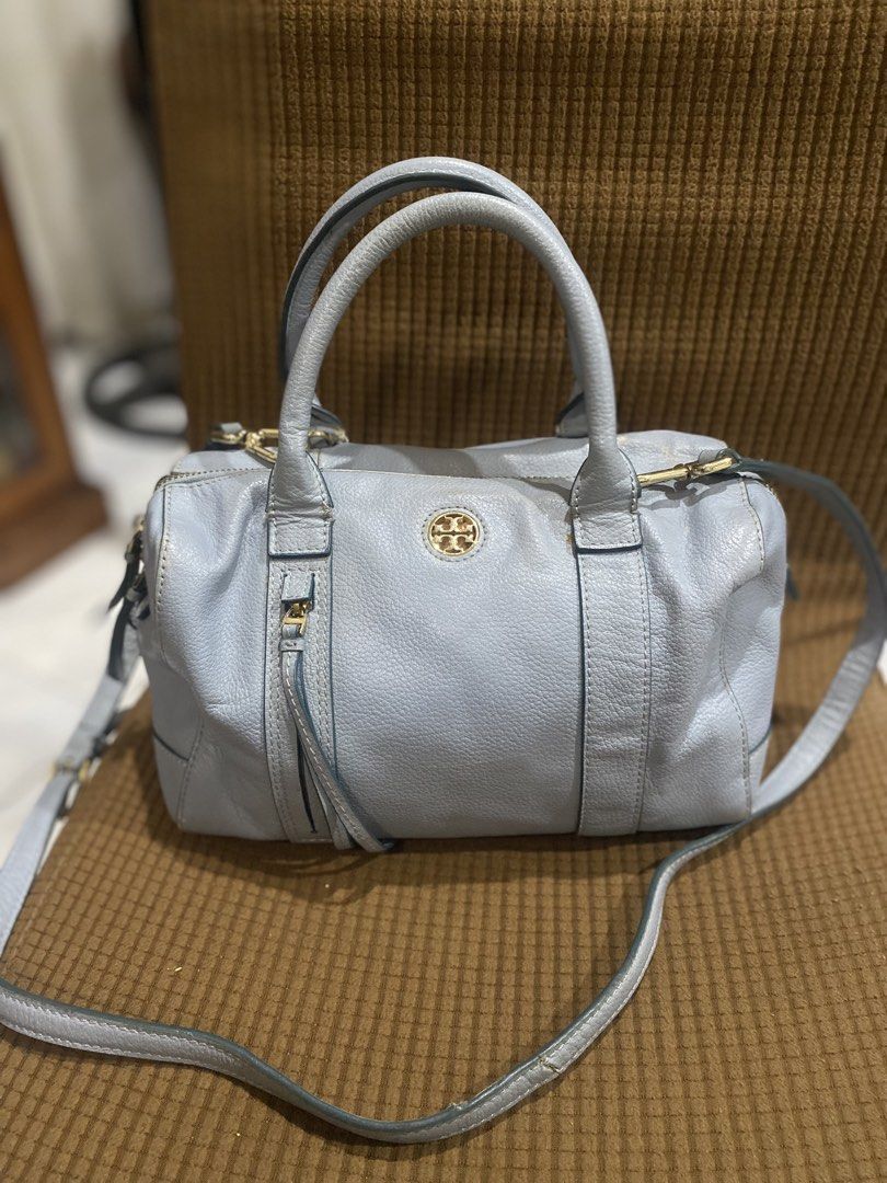 Tory Burch Blue Leather Satchel Bag (Category: Luxury Bags & Wallets) located in Cadiz. Submitted by saveandstyleph (Listing ID 1436414651, Image 1). Description: - Tory Burch satchel bag - Light blue leather exterior - Gold-tone hardware - Top handle and detachable shoulder strap - Zip closure - Iconic logo emblem - Spacious interior - Classic design for everyday wear.