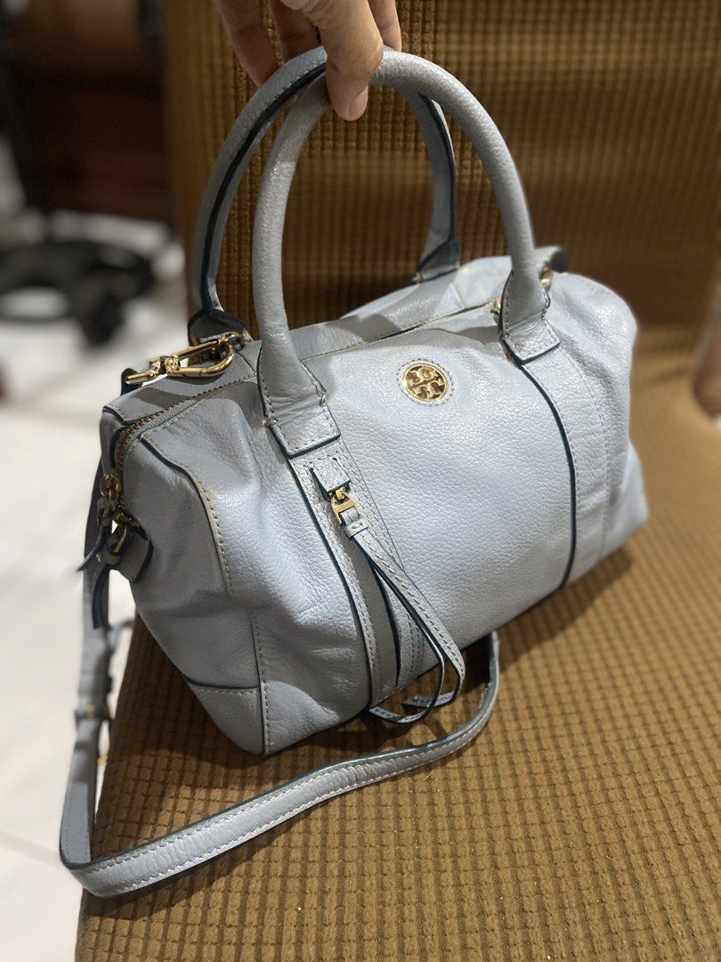 Tory Burch Blue Leather Satchel Bag (Category: Luxury Bags & Wallets) located in Cadiz. Submitted by saveandstyleph (Listing ID 1436414651, Image 3). Description: - Tory Burch satchel bag - Light blue leather exterior - Gold-tone hardware - Top handle and detachable shoulder strap - Zip closure - Iconic logo emblem - Spacious interior - Classic design for everyday wear.
