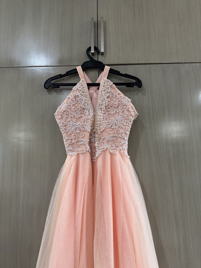 Vee Tan Halter Neck Formal Prom Gown (Category: Evening dresses & gowns) located in San Juan City. Submitted by okkmegan (Listing ID 1436401086, Image 3). Description: - Vee Tan formal gown - Halter neck design - Intricate lace bodice - Flowing, layered peach skirt - Ideal for special events - Flattering silhouette - Well-maintained condition BODY MEASUREMENTS Height: 5’1 with 3in heels Bust: 32A Waist: 23in Weight: 90lbs.