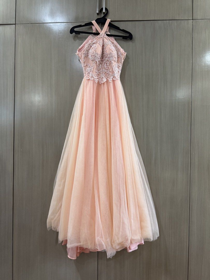 Vee Tan Halter Neck Formal Prom Gown (Category: Evening dresses & gowns) located in San Juan City. Submitted by okkmegan (Listing ID 1436401086, Image 1). Description: - Vee Tan formal gown - Halter neck design - Intricate lace bodice - Flowing, layered peach skirt - Ideal for special events - Flattering silhouette - Well-maintained condition BODY MEASUREMENTS Height: 5’1 with 3in heels Bust: 32A Waist: 23in Weight: 90lbs.