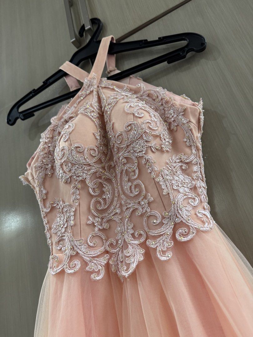 Vee Tan Halter Neck Formal Prom Gown (Category: Evening dresses & gowns) located in San Juan City. Submitted by okkmegan (Listing ID 1436401086, Image 2). Description: - Vee Tan formal gown - Halter neck design - Intricate lace bodice - Flowing, layered peach skirt - Ideal for special events - Flattering silhouette - Well-maintained condition BODY MEASUREMENTS Height: 5’1 with 3in heels Bust: 32A Waist: 23in Weight: 90lbs.