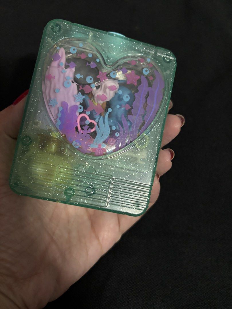Vintage Heart-Shaped Toy (Category: Kids Toys) located in San Juan City. Submitted by ywkly (Listing ID 1436456233, Image 1). Description: - Vintage heart-shaped toy - Features an underwater scene - Includes a blue octopus and other sea creatures - Light green color - Has a button on the side.