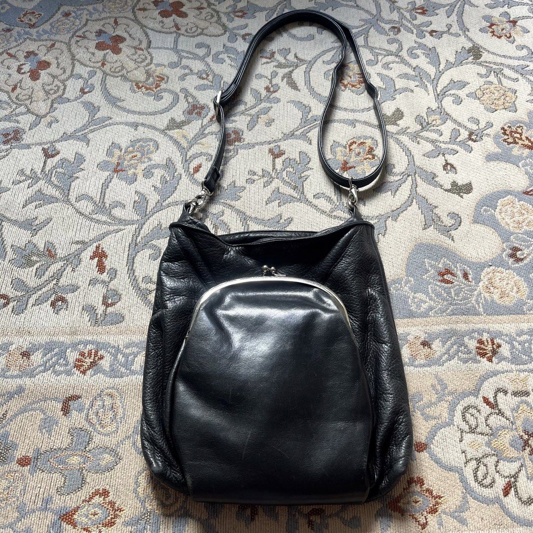 Yohji Yamamoto +Noir Fall/Winter 1997 Archive Gamaguchi Clasp Kisslock Crossbody Bag (Category: Cross-body Bags) located in Silang. Submitted by f4iry4rch1ve (Listing ID 1436351311, Image 1). Description: Yohji Yamamoto +Noir Fall/Winter 1997 Archive Gamaguchi Clasp Kisslock Crossbody Bag 8250 php+ sf Condition: 8.5/10, the same some leather scuffings on the kisslock compartment Dimensions: L: 10 inches , W: 9 inches - main compartment leather is