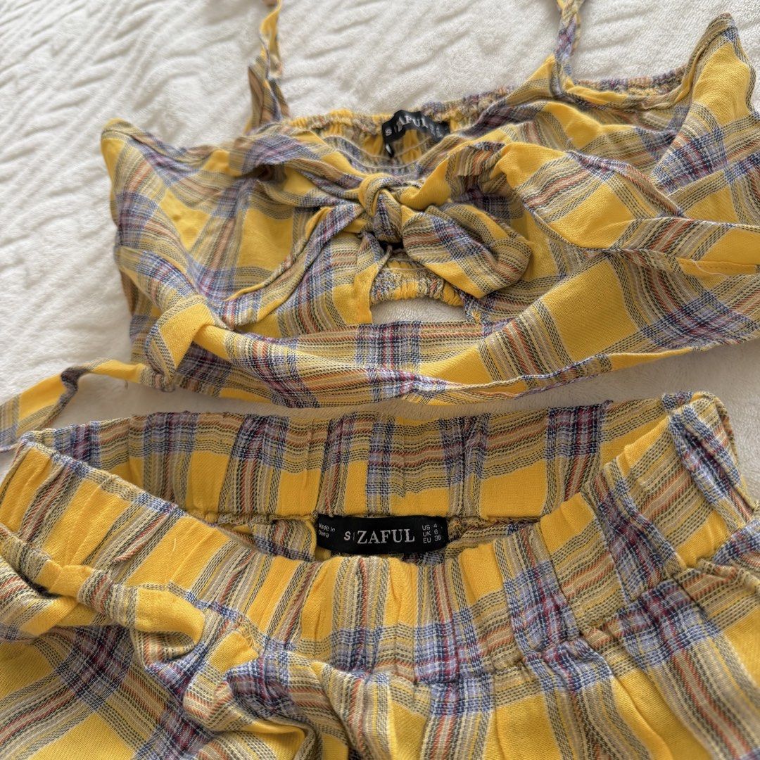 Zaful Plaid Crop Top and Pants Set (Category: Sets or Coordinates) located in Pasig City. Submitted by sichi.ph (Listing ID 1436369103, Image 2). Description: - Zaful yellow plaid two-piece set. - Includes a crop top and wide-leg pants. - Crop top features: spaghetti straps, tie-front. - Pants feature: elastic waistband. - Fabric: Lightweight, ideal for warm weather. - Size tag is visible in the photos..