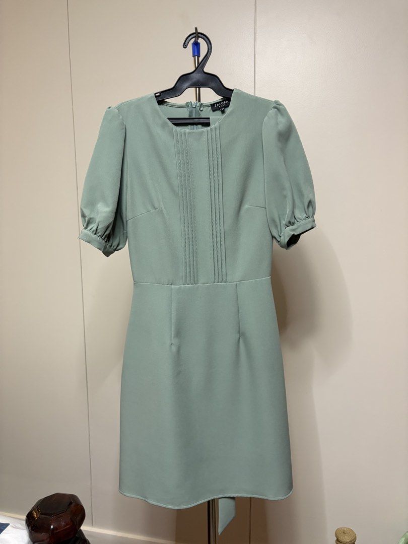 ZALORA Green Dress (Category: Dresses) located in Taguig. Submitted by pomupuff (Listing ID 1436403124, Image 1). Description: MOP: BPI Delivery via grab or lalamove - ZALORA green dress - Round neckline - Short puff sleeves - Fitted bodice with pleat details - Defined waist - Straight skirt - Back zipper closure - Suitable for formal events or everyday wear.