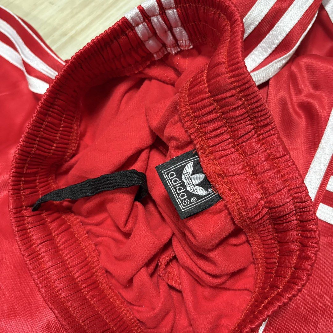 Adidas Red Track Pants with White Stripes (Category: Other Bottoms) located in Rizal. Submitted by thriftdrip.402 (Listing ID 1436605133, Image 3). Description: - Adidas track pants in red - White stripes on sides - Adidas trefoil logo - Elastic waistband - Satin-like fabric - Perfect for a sporty look - 25-32 Waist - 38 Length - 8 Leg Hole.
