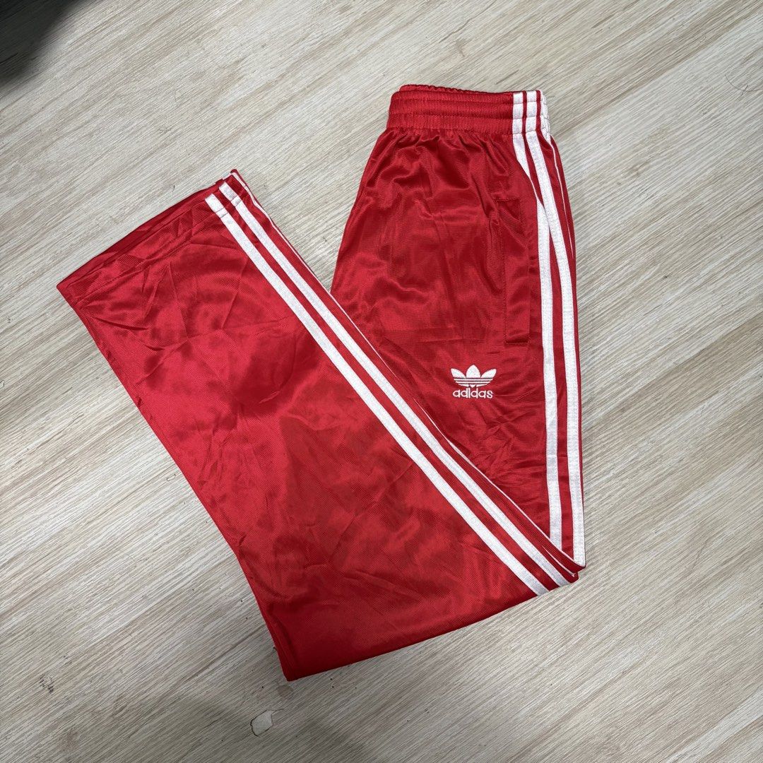 Adidas Red Track Pants with White Stripes (Category: Other Bottoms) located in Rizal. Submitted by thriftdrip.402 (Listing ID 1436605133, Image 1). Description: - Adidas track pants in red - White stripes on sides - Adidas trefoil logo - Elastic waistband - Satin-like fabric - Perfect for a sporty look - 25-32 Waist - 38 Length - 8 Leg Hole.
