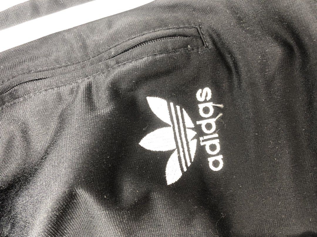 Adidas Track Pants - Black with White Stripes (Category: Activewear) located in Midsayap. Submitted by karldonor01258 (Listing ID 1436499928, Image 3). Description: Classic Adidas track pants in black with white stripes. Features the Adidas logo on the leg and a size M tag. Includes a drawstring waist and side pockets. There is a small hole on the back of the pants. Perfect for casual wear or workouts. -Dimes:W38 L42 -leg hole:8.