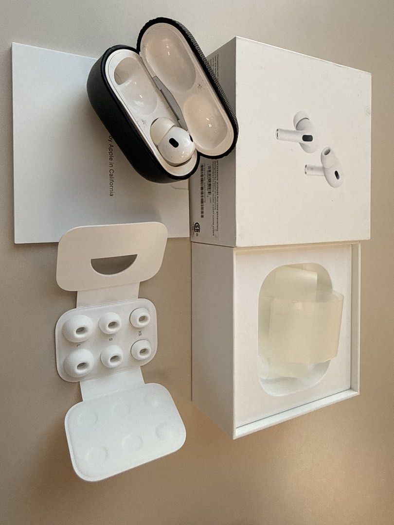 Apple AirPods Pro 2nd Generation (Category: Earphones) located in Caloocan City. Submitted by kielmarxi38357 (Listing ID 1436559311, Image 2). Description: Apple AirPods Pro 2nd Generation. Includes the charging case, extra ear tips, and the original box. The charging case has a black protective cover. The earphones are white. The box shows the AirPods Pro design. The accessories appear to be complete. Missing Left Bud.