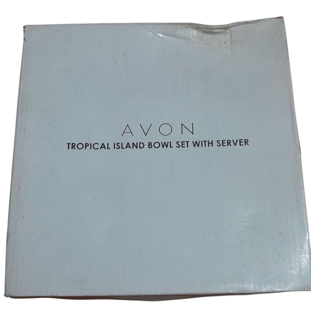 Avon Tropical Island Bowl Set with Server (Category: Dinnerware & Cutlery) located in Mandaluyong City. Submitted by twixie94147 (Listing ID 1436515785, Image 2). Description: - Avon Tropical Island Bowl Set with Server - Includes 1 big bowl (22.7cm diameter) and 4 small bowls (12.8cm diameter). - Made of white porcelain with a tropical design. - Features blue rims..