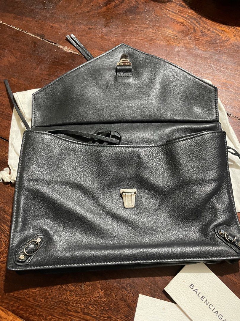 Balenciaga Black Leather Clutch (Category: Luxury Bags & Wallets) located in Calamba. Submitted by eskaparatengpuno (Listing ID 1436610379, Image 3). Description: - Authentic Balenciaga Balco Leather Papier Sight clutch - Black textured leather - Front zip pocket - Flap closure - Single interior compartment - Includes dust bag and tags .
