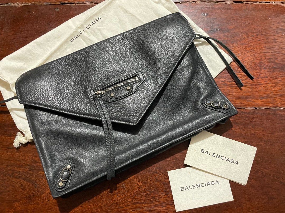 Balenciaga Black Leather Clutch (Category: Luxury Bags & Wallets) located in Calamba. Submitted by eskaparatengpuno (Listing ID 1436610379, Image 1). Description: - Authentic Balenciaga Balco Leather Papier Sight clutch - Black textured leather - Front zip pocket - Flap closure - Single interior compartment - Includes dust bag and tags .