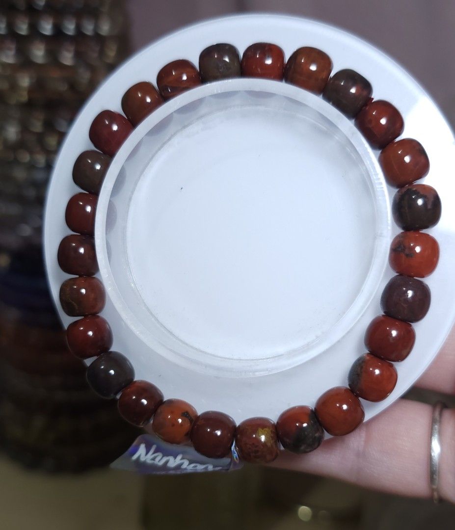 Baojiang nanhong Bracelet (Category: Bracelets) located in Batangas. Submitted by finestonesandfindsph (Listing ID 1436632922, Image 1). Description: - Round, reddish-brown beads - Color variations within the beads - Strung on an elastic band - Shown on a white surface.
